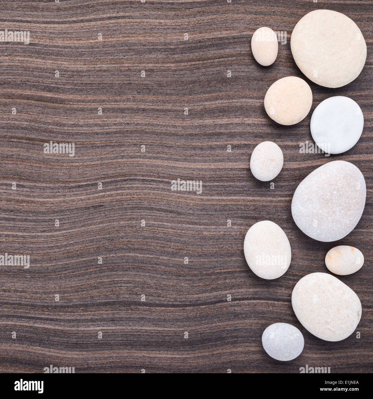 light stones on wooden ebony tree background Stock Photo