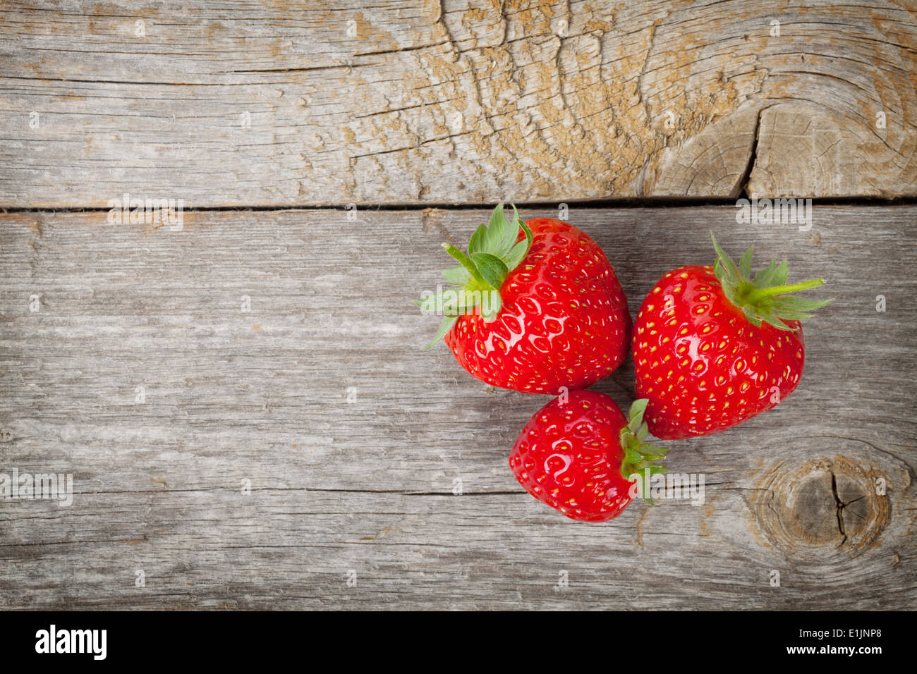Ripe strawberries over wooden table background with copy space Stock ...