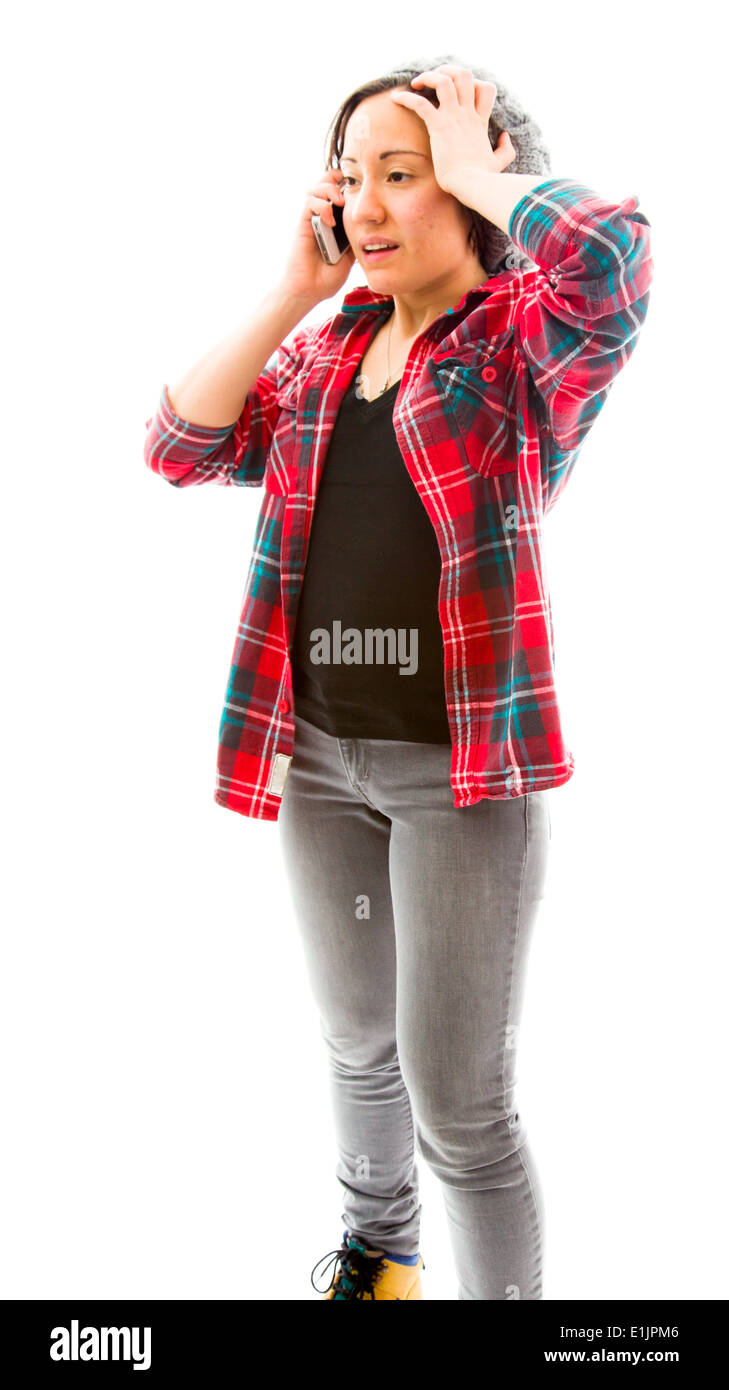 Young woman talking on mobile phone with her hand on her head Stock Photo