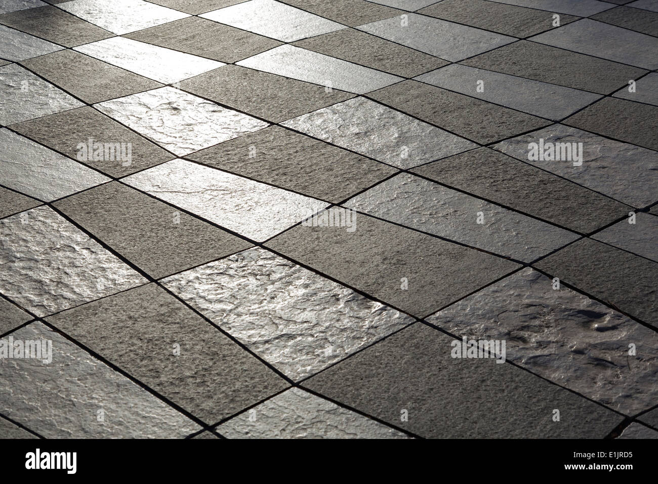 Pavement built of white and black stone slabs Stock Photo