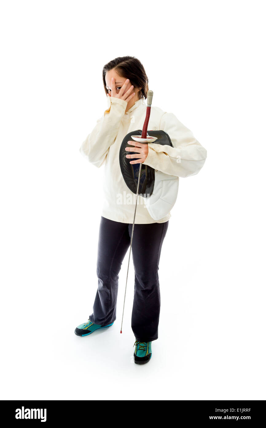 Female fencer peeking through hands covering face Stock Photo