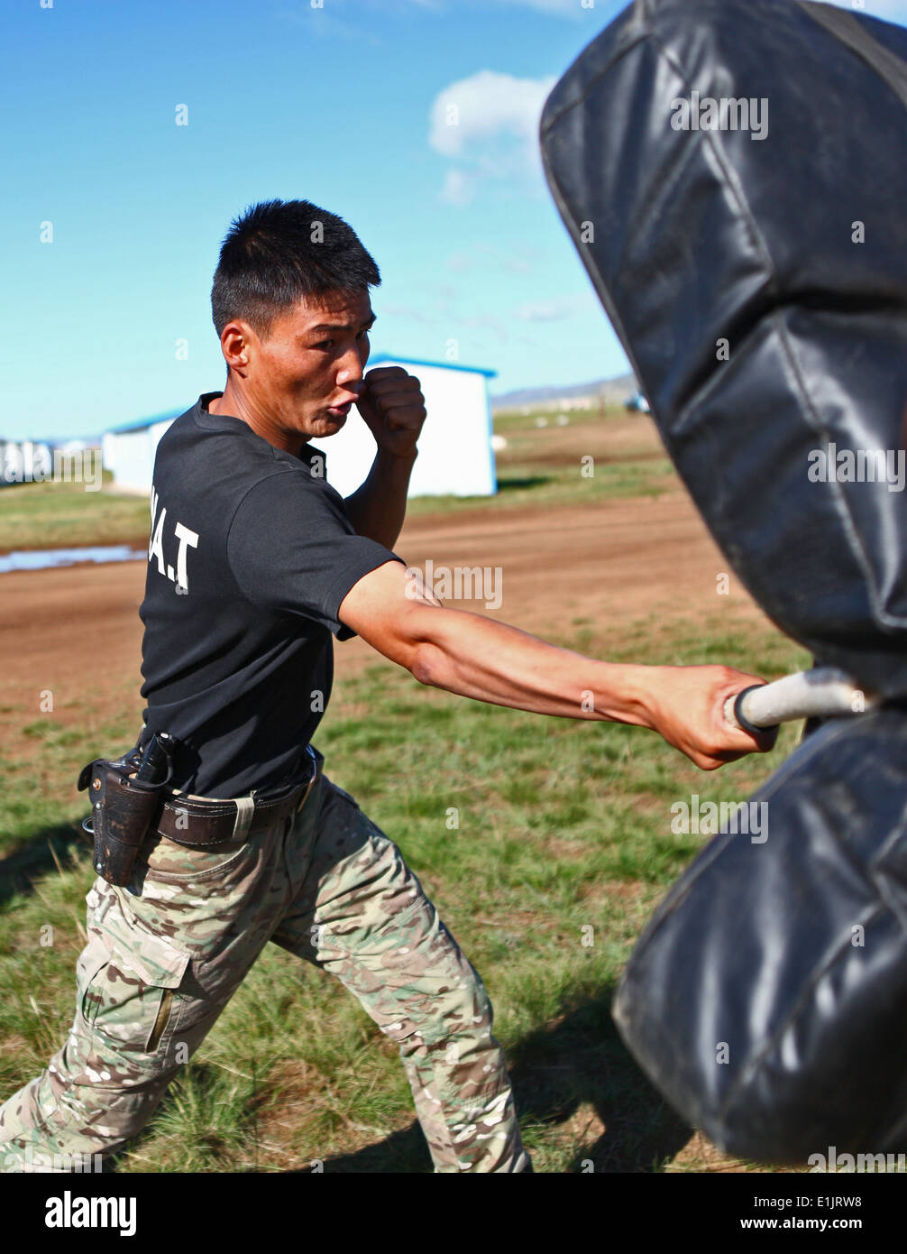 A member of the Mongolian Armed Forces participates in a pepper spray qualification course as part of the Non-Lethal Weapons Ex Stock Photo