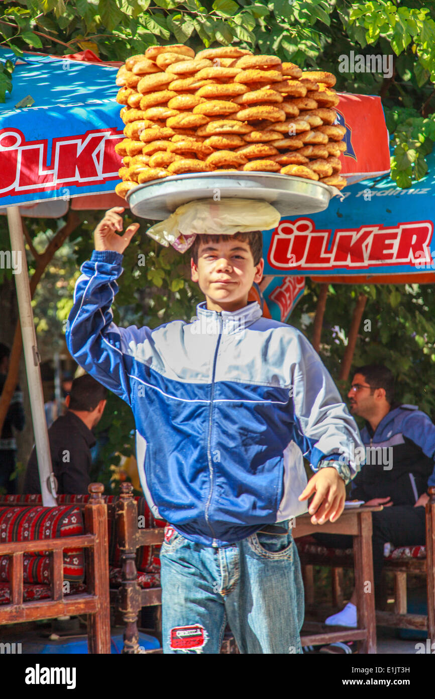 Young boy carries donuts on the head Stock Photo