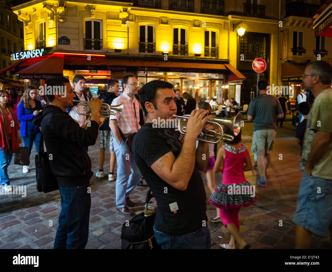 Street musicians play late in the evening at the Paris latin quarter / quartier latin. Stock Photo