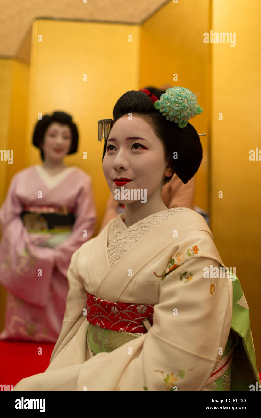 Two apprentice geisha, maiko, sitting in a banquet hall. Stock Photo