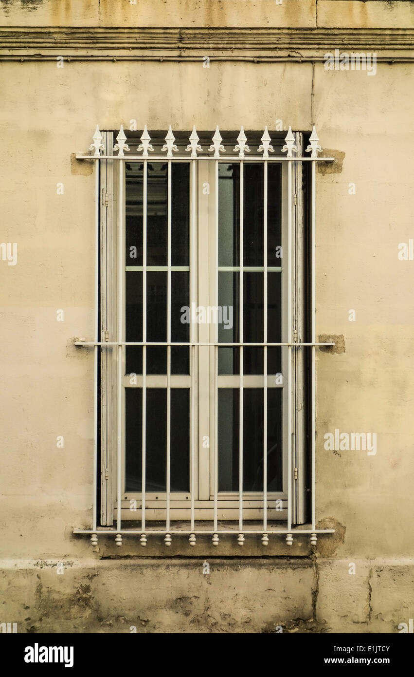 A window with white grids sealed to walls Stock Photo