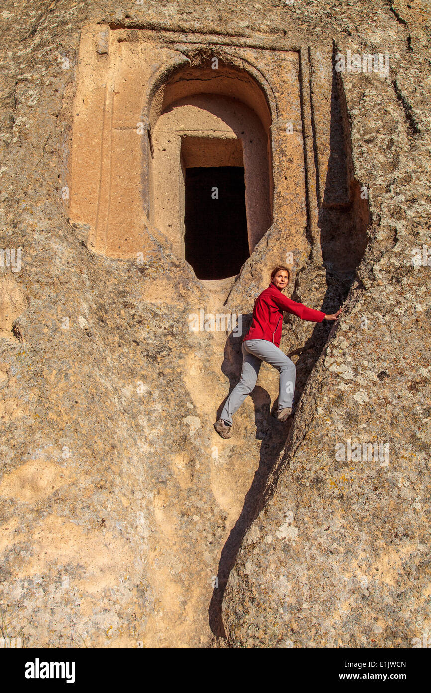 Climbing to enter a carved church in Selime Stock Photo