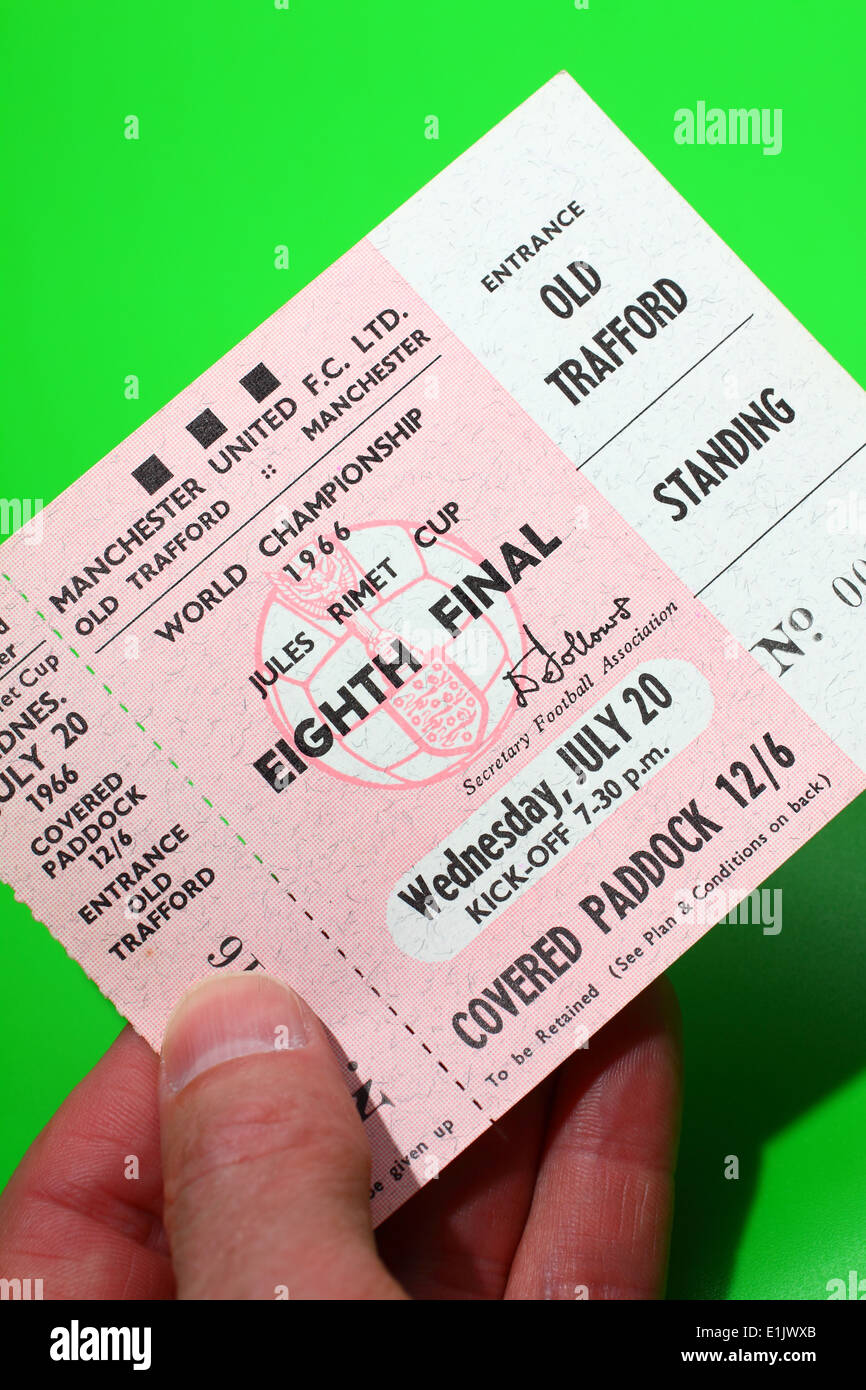 Person holding original 1966 World Cup tickets for the Eighth Final match - Hungary V Bulgaria on a green background Stock Photo