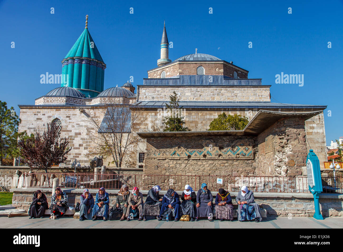 Turkish women sitting in front Mevlana museum Stock Photo