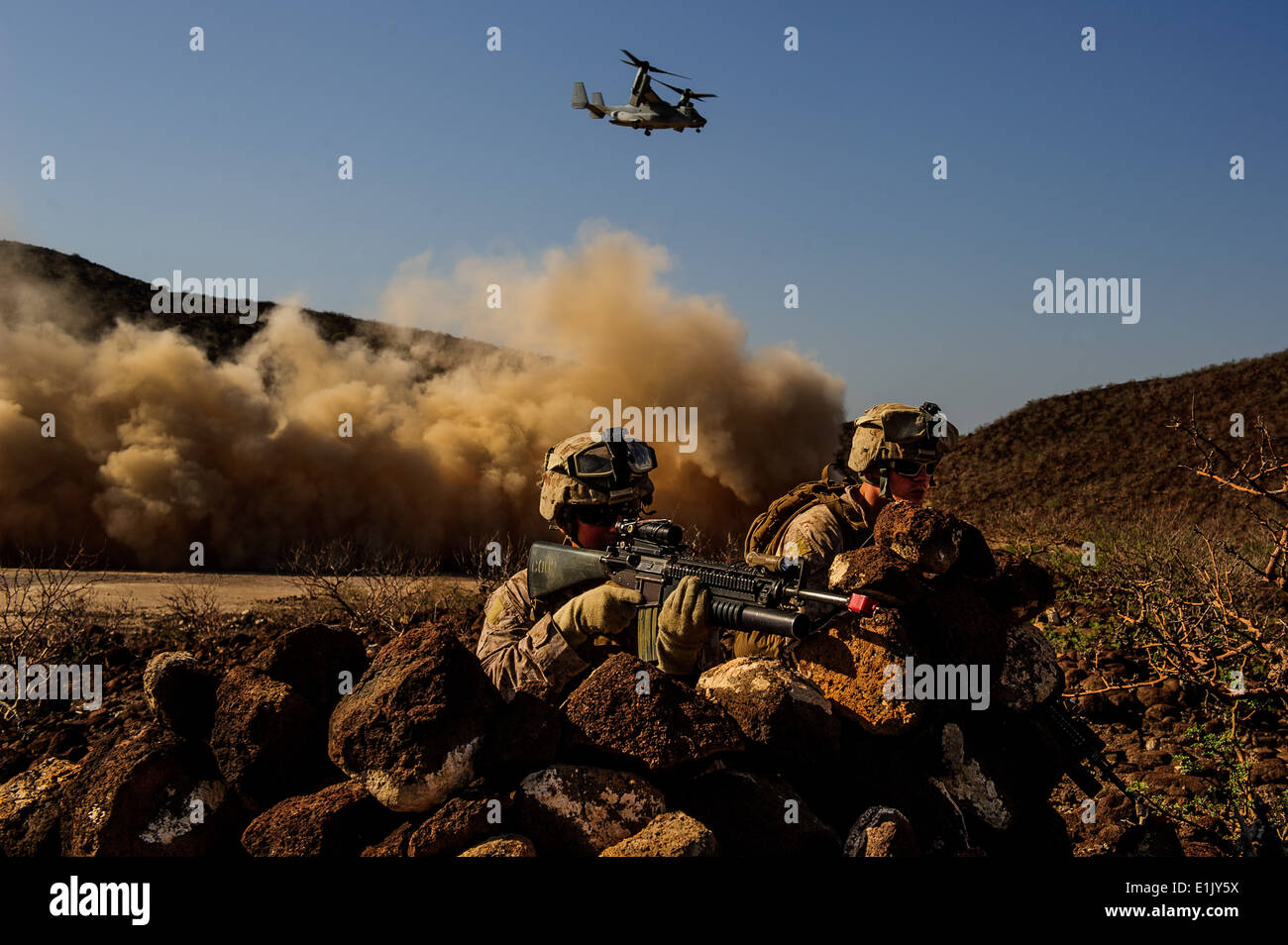U.S. Marines with Battalion Landing Team 1/4 (BLT), 13th Marine Expeditionary Unit (MEU) post security while a MV-22 Osprey tak Stock Photo