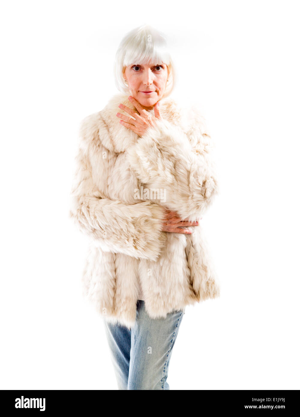 Senior woman standing with her hand on chin Stock Photo