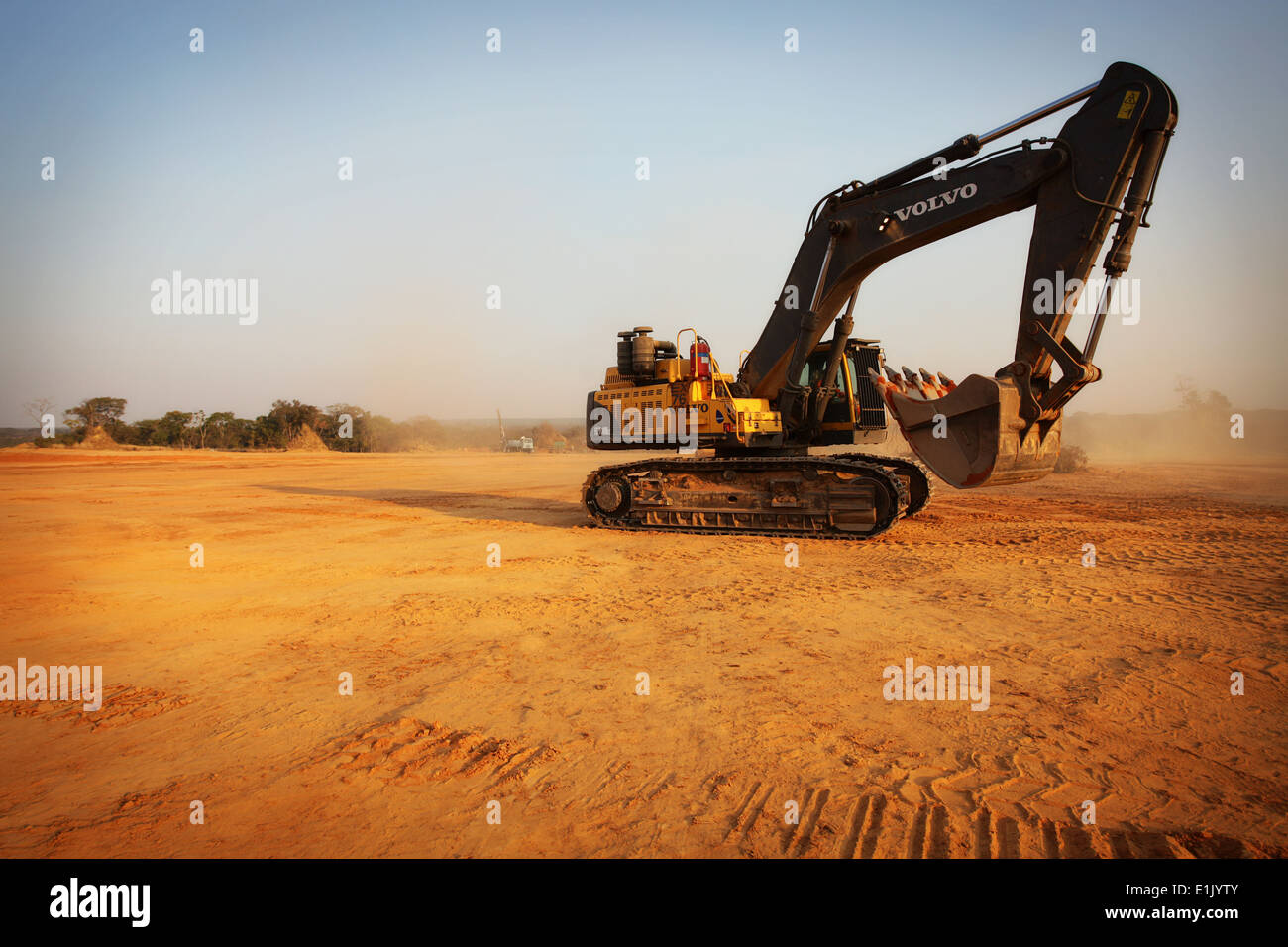 Digger excavator at sunset on a copper mine in Zambia Stock Photo