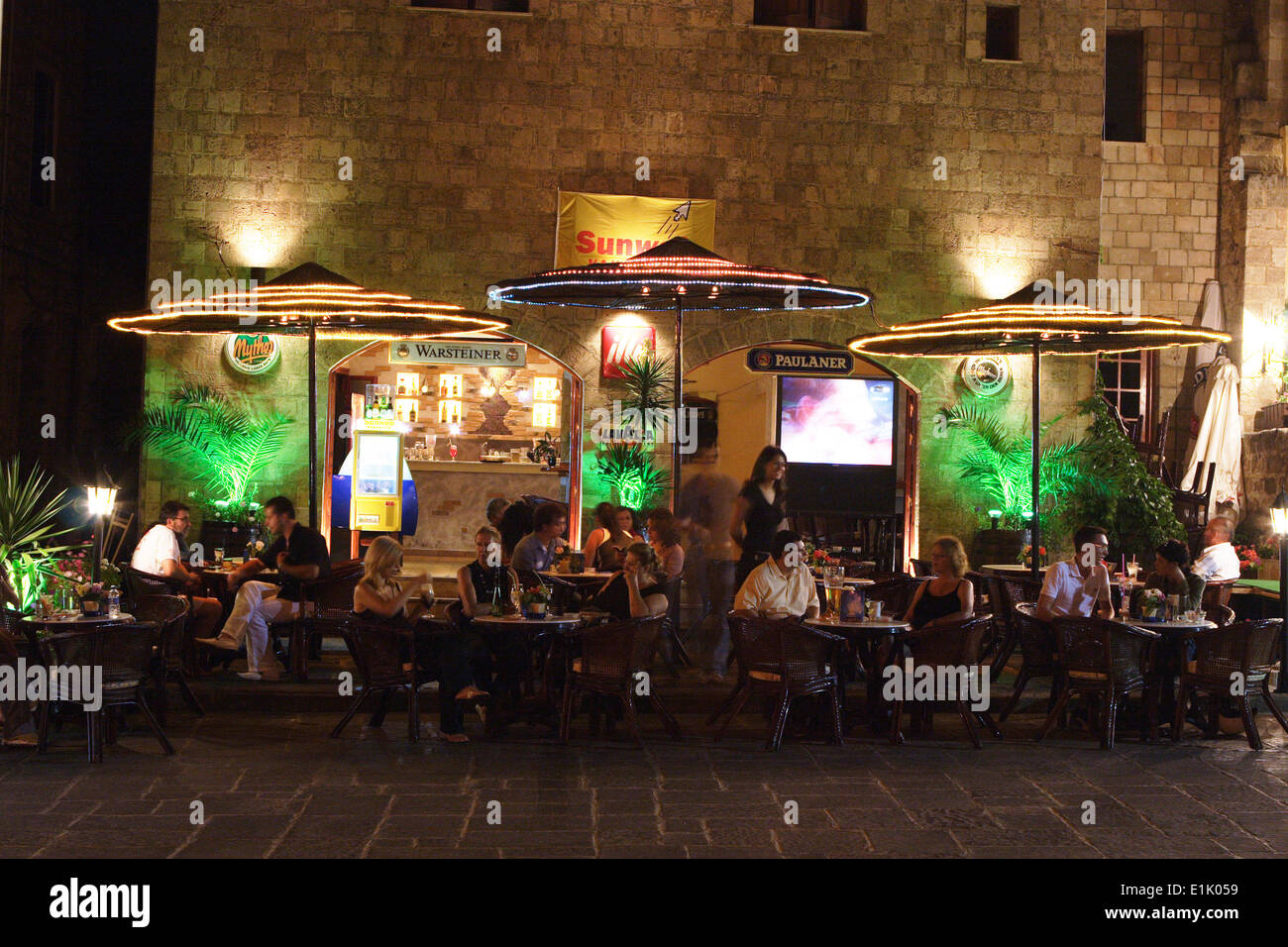 People dining outside on the streets of Rhodes, Rhodes Island, Greece Stock Photo