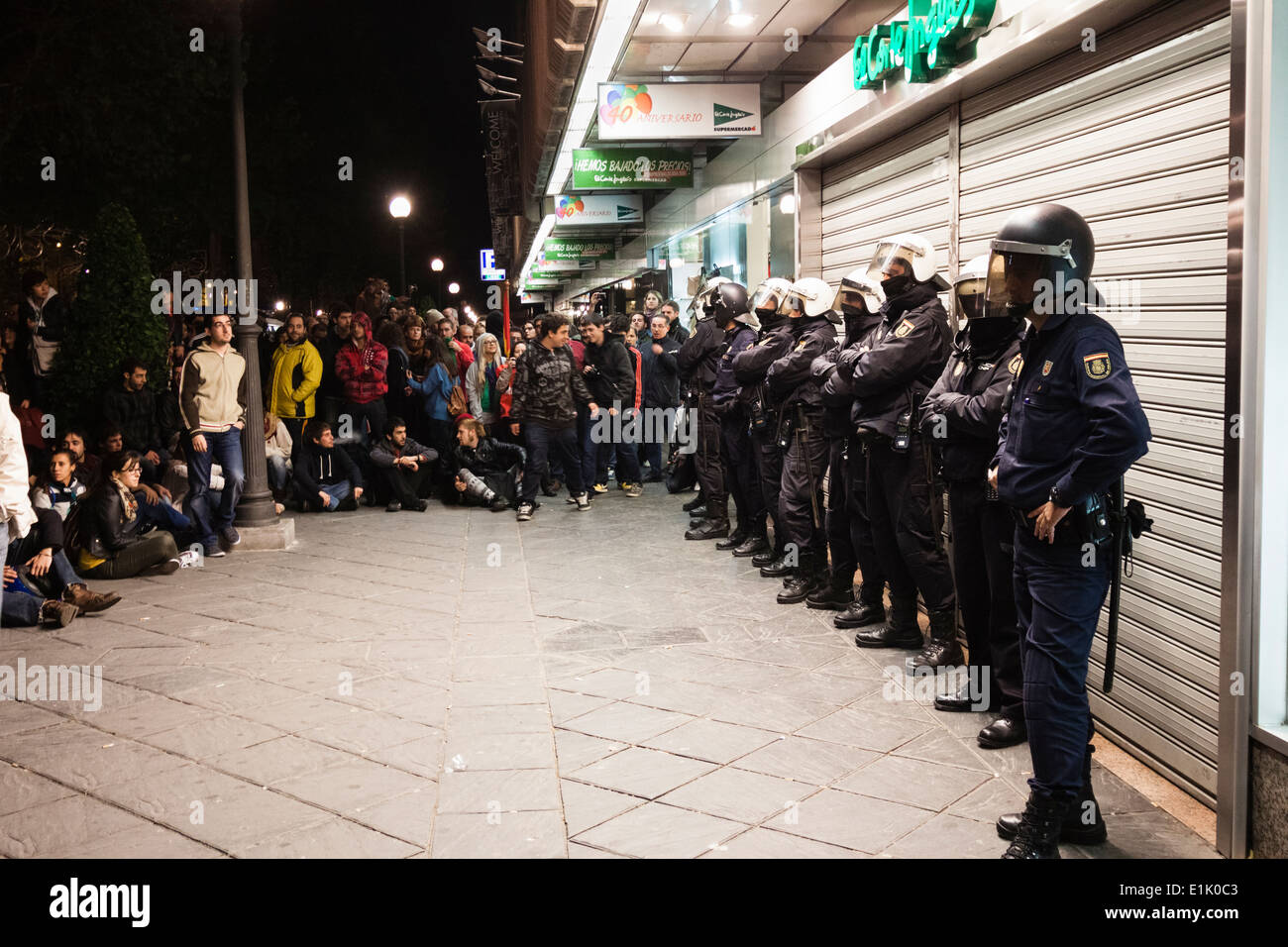 Protesters gather around police forces protecting the open department store 'El Corte Inglés' during general strike Stock Photo