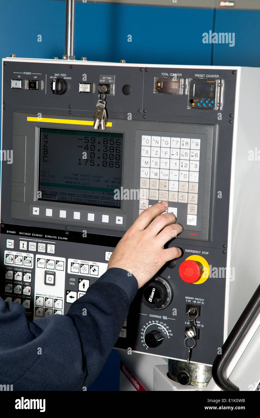Man hand the controls of a machine CNC Stock Photo