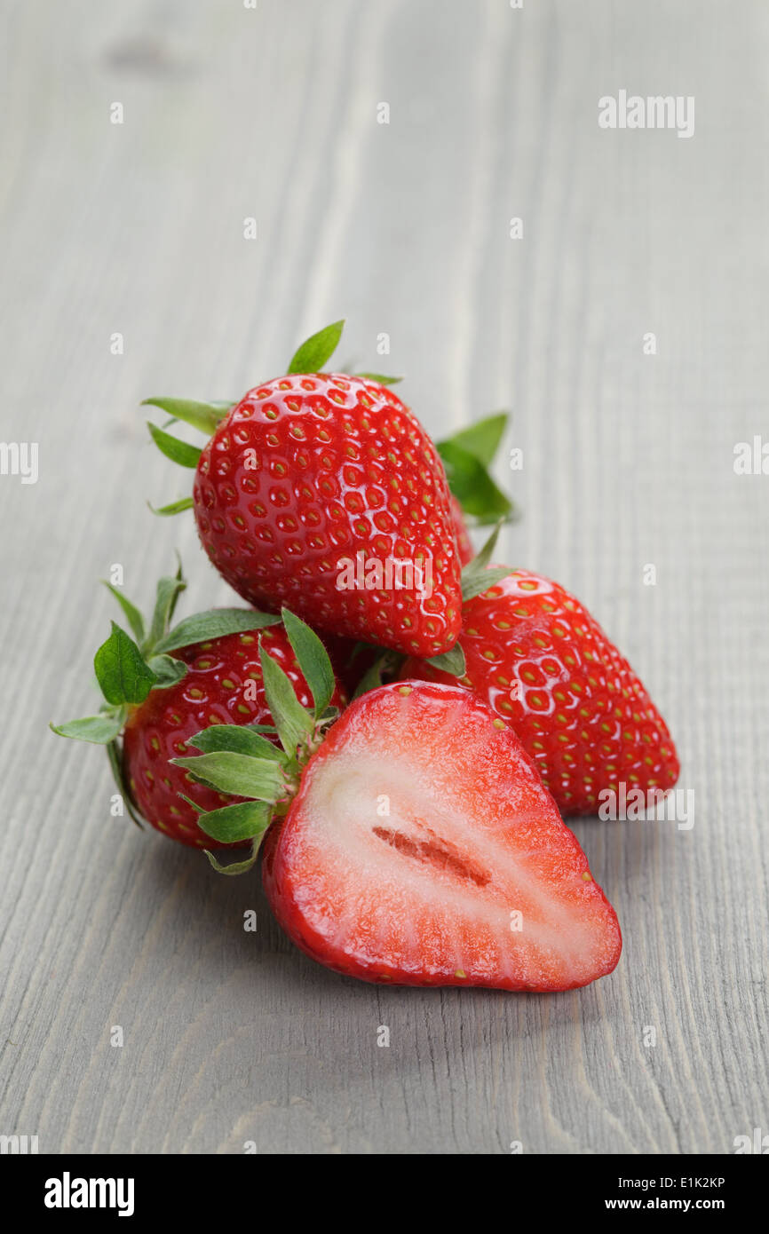 fresh ripe strawberries on rustic wood table, close up photo Stock ...