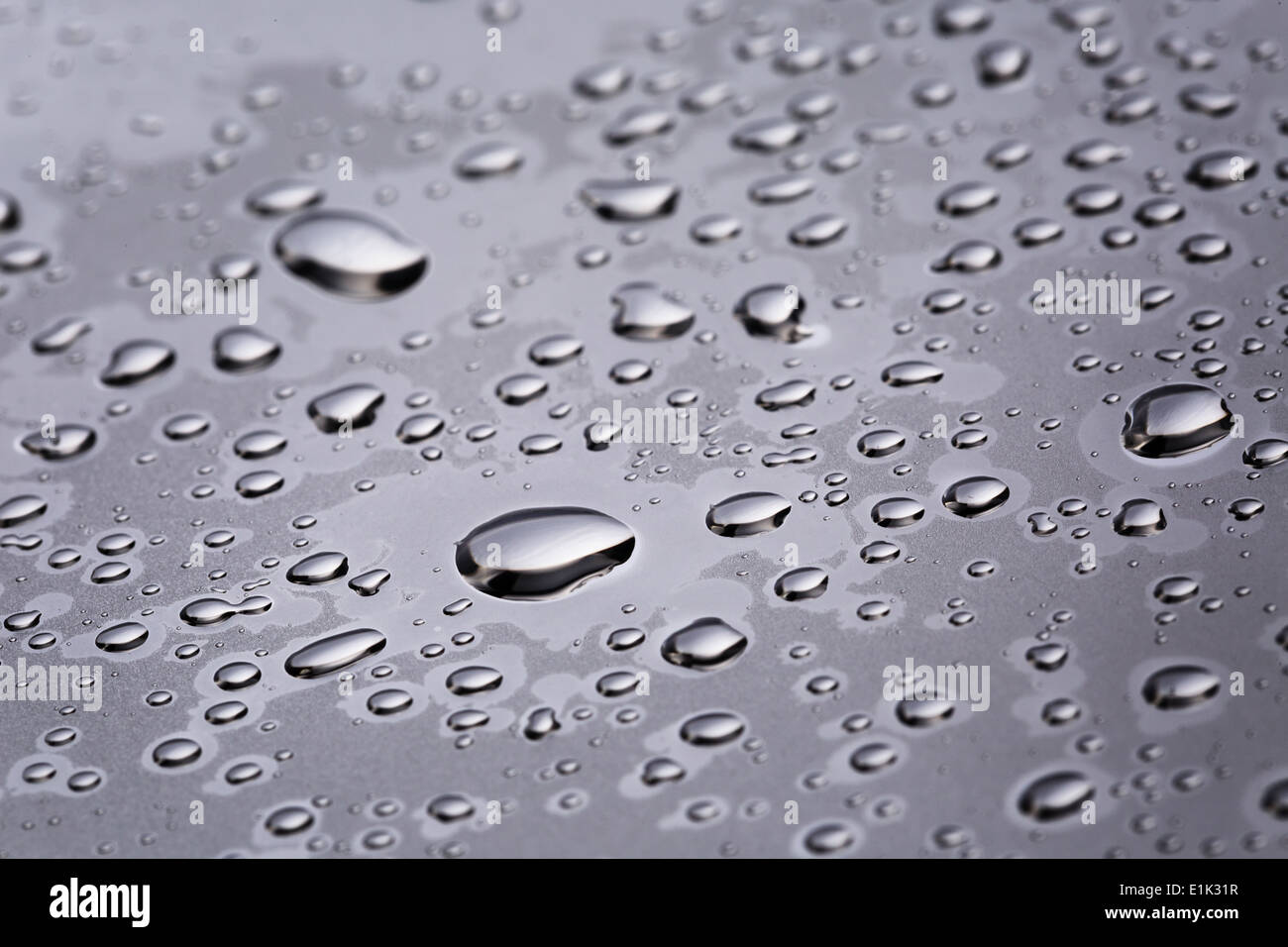 abstract water drops on polished stainless steel surface, close up Stock Photo
