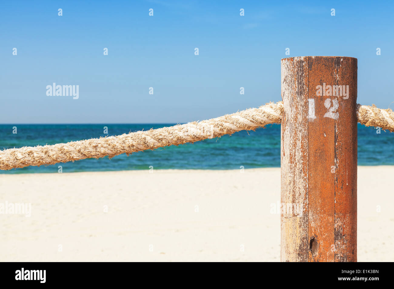 Beach border railing with rope in the summer day Stock Photo - Alamy