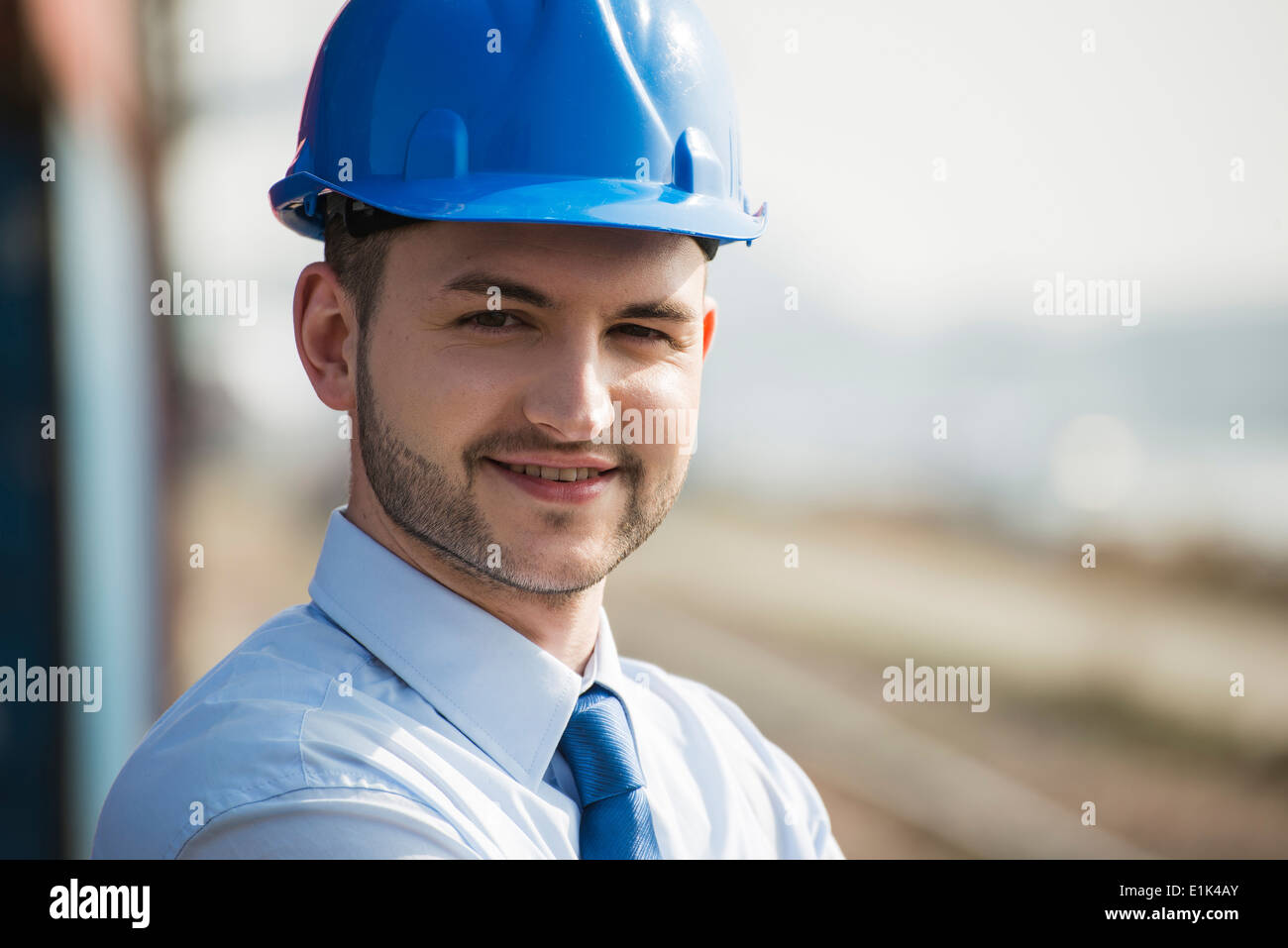 Portrait of businessman wearing blue hard hat Stock Photo Alamy