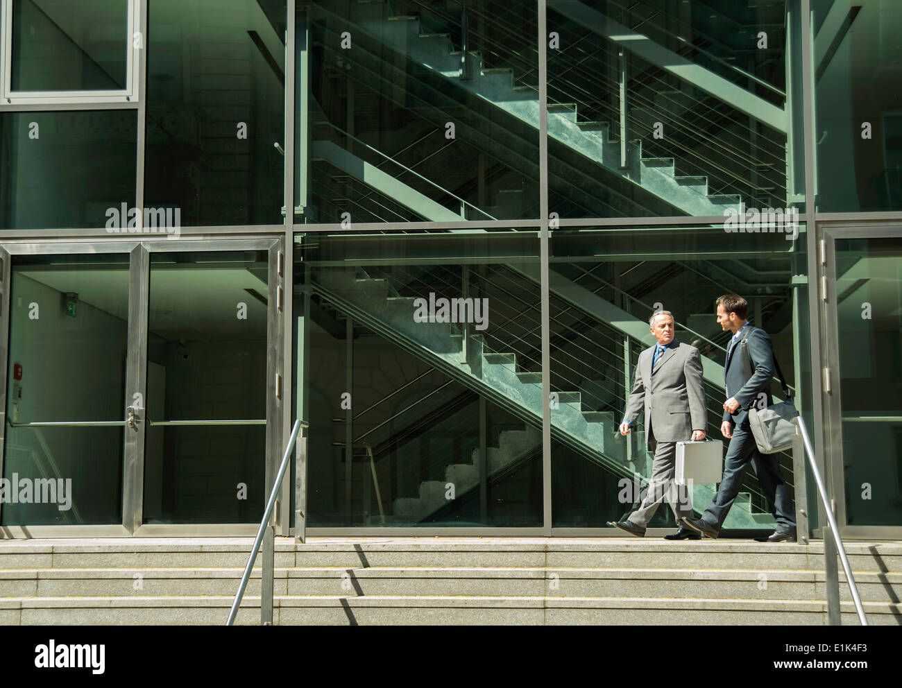 Two businessmen talking outside office building Stock Photo - Alamy