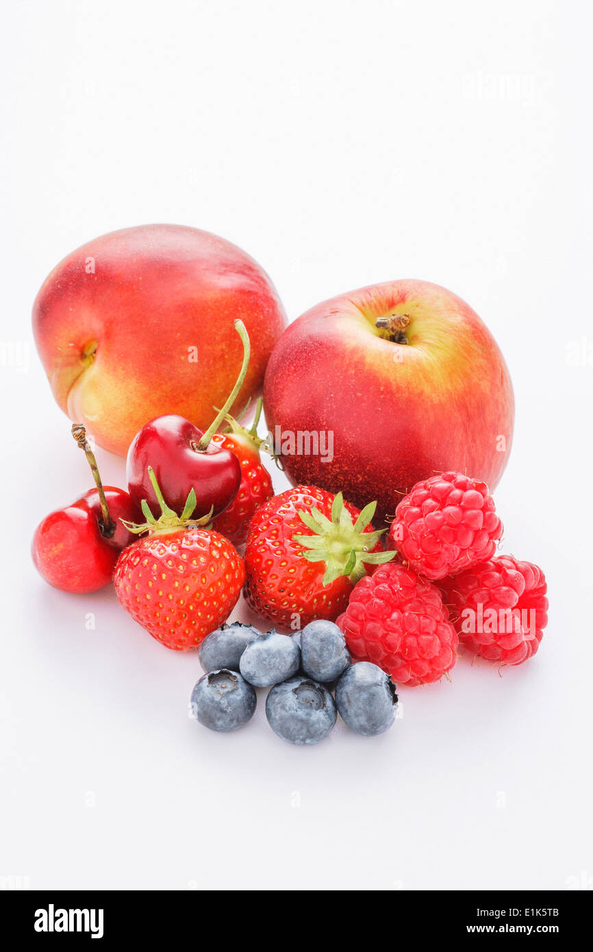 A selection of mixed fruit on a white background These include cherries nectarines strawberries plums blueberries and Stock Photo