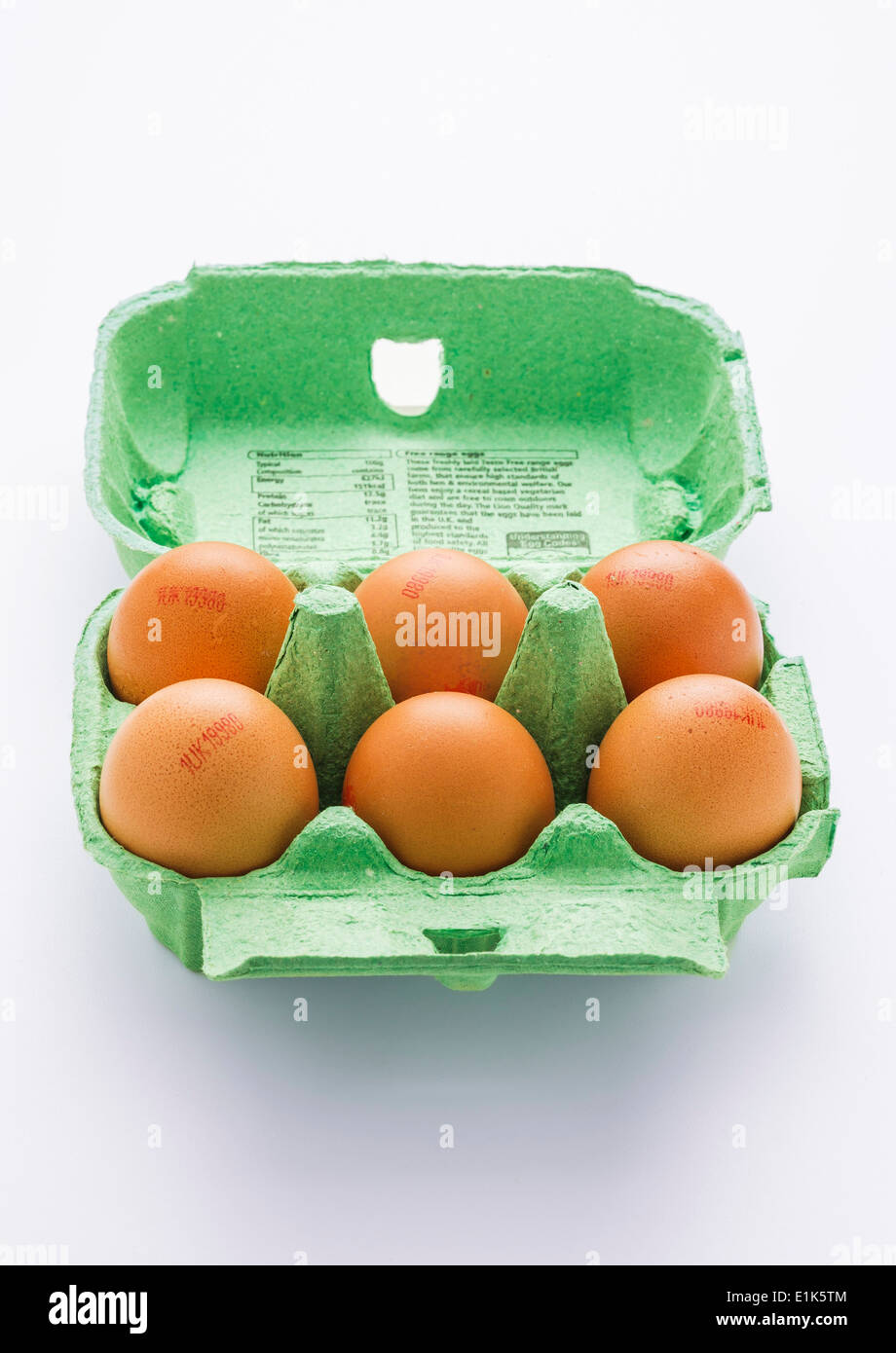 Chicken eggs in their carton on a white background Stock Photo - Alamy