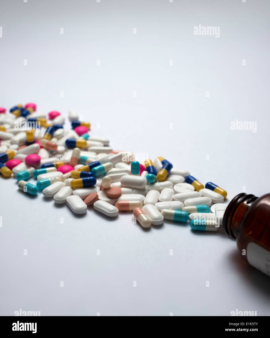 Pills spilling out of bottle Stock Photo