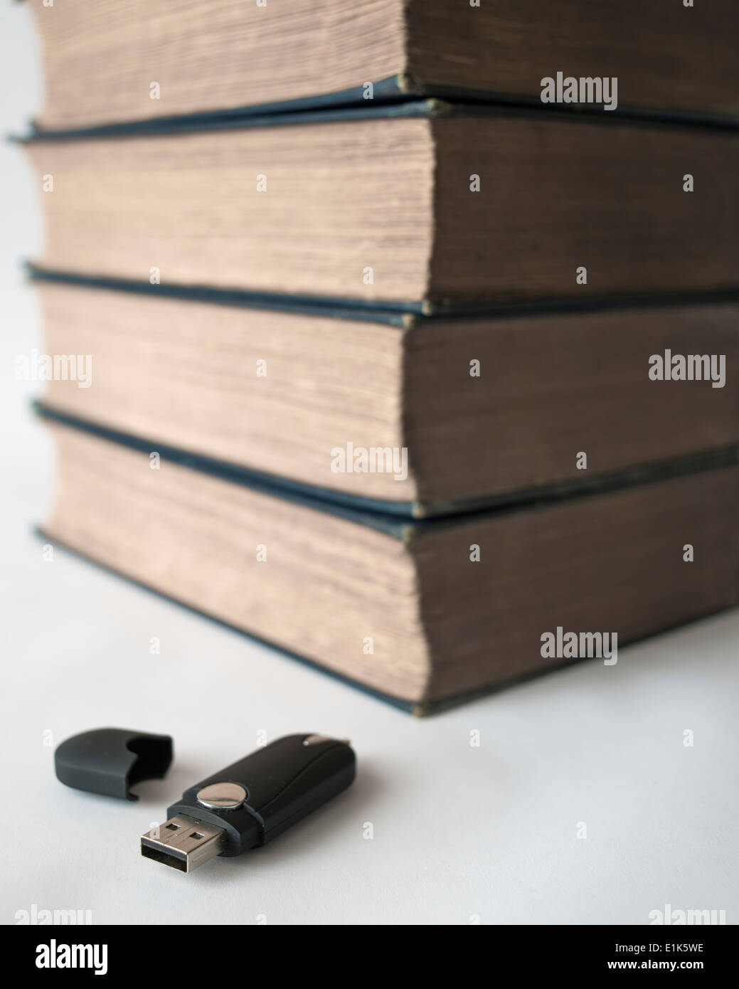 64gb USB flash drive and 100 year old books (each book of around 600 pages is equivalent to less than 1 megabyte so the drive Stock Photo