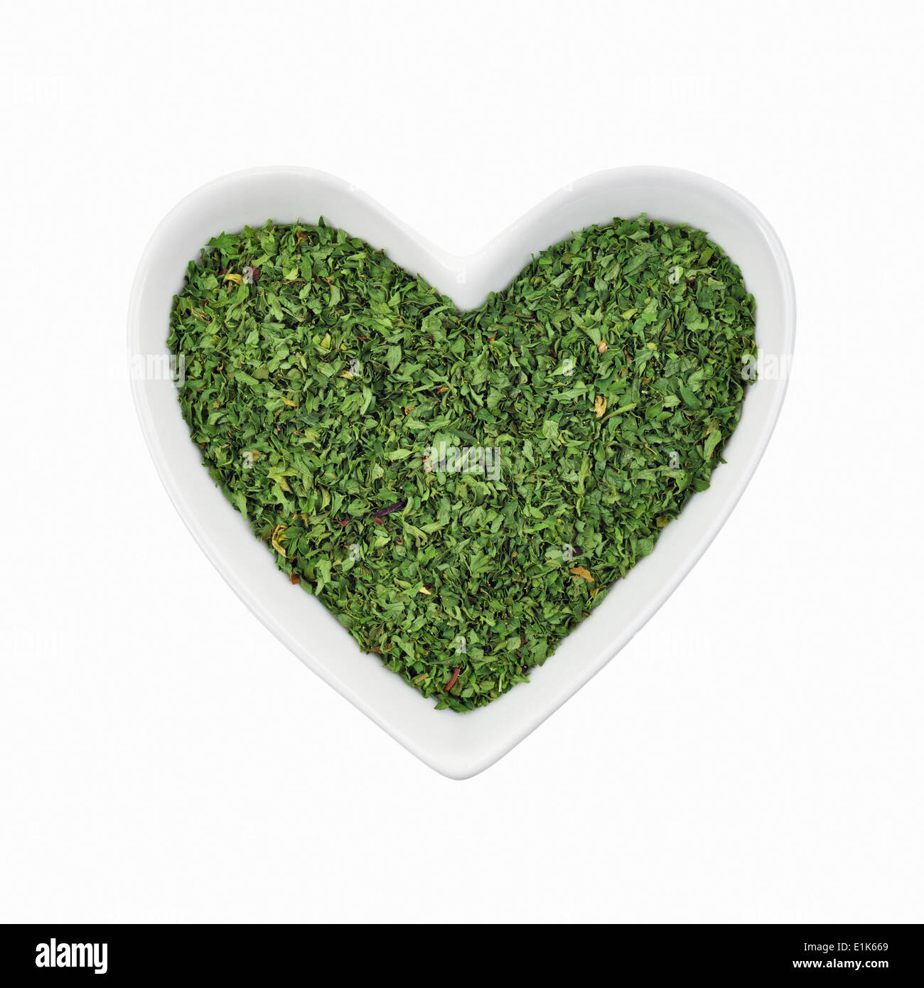 Parsley (Petroselinum crispum) in a heart-shaped dish. Stock Photo