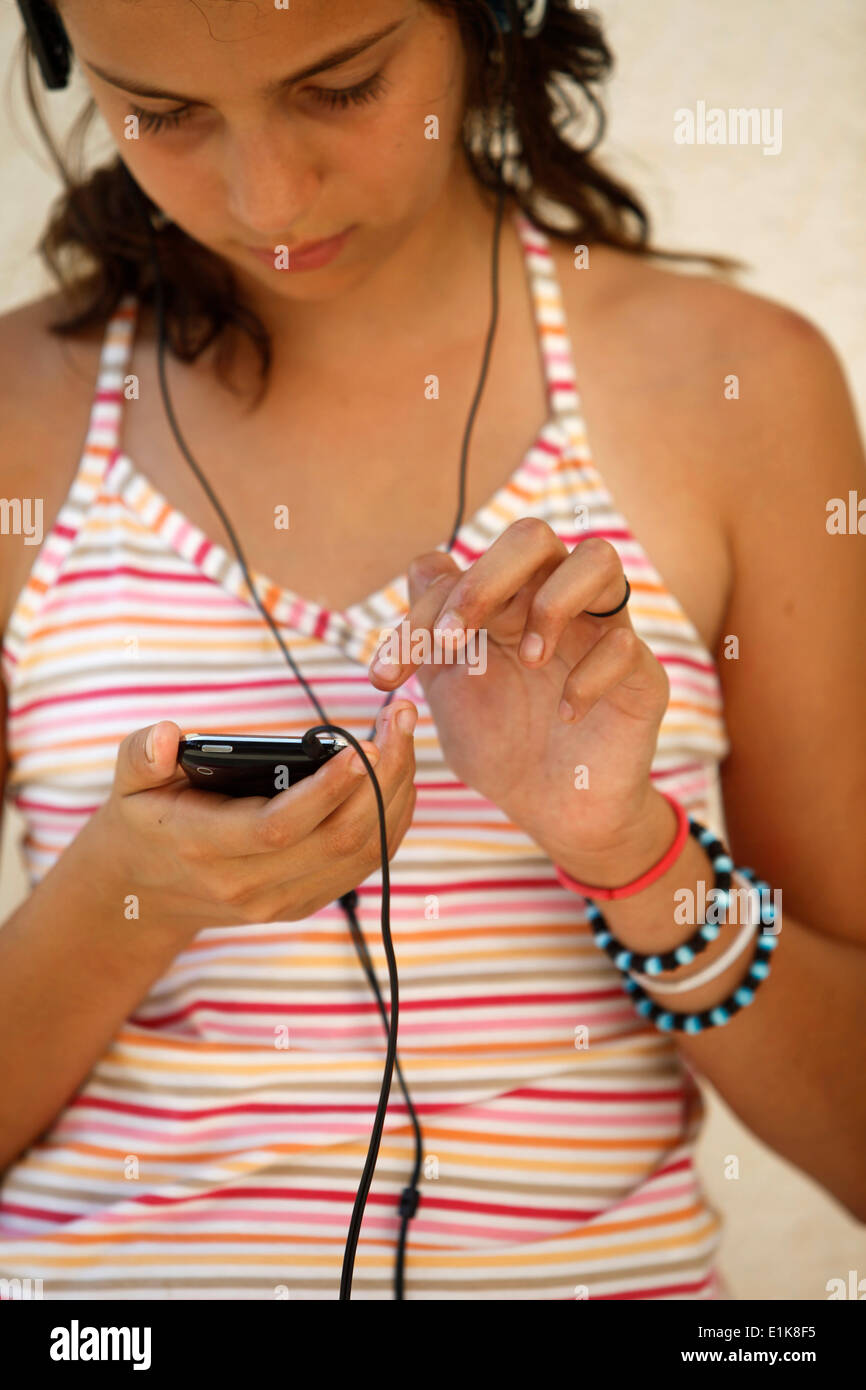 Girl listening to music on iphone Stock Photo