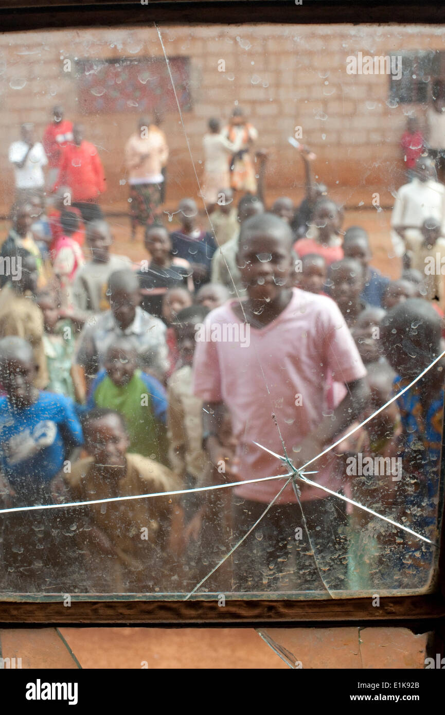 Pupils in a school in Burundi seen through a broken window Stock Photo