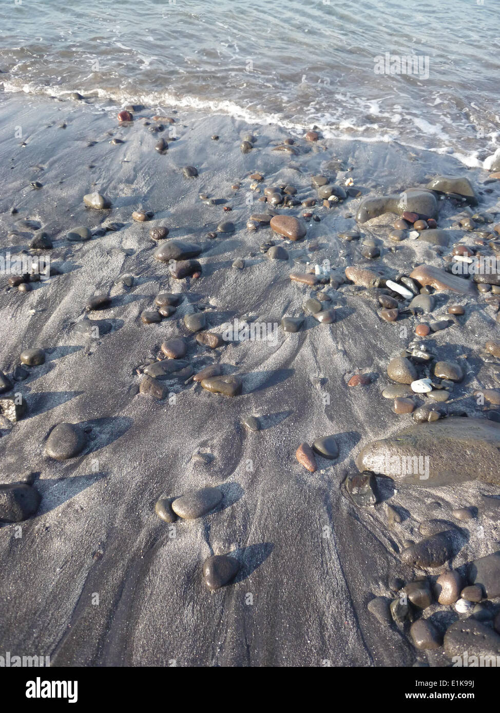 Dark sand beach Stock Photo