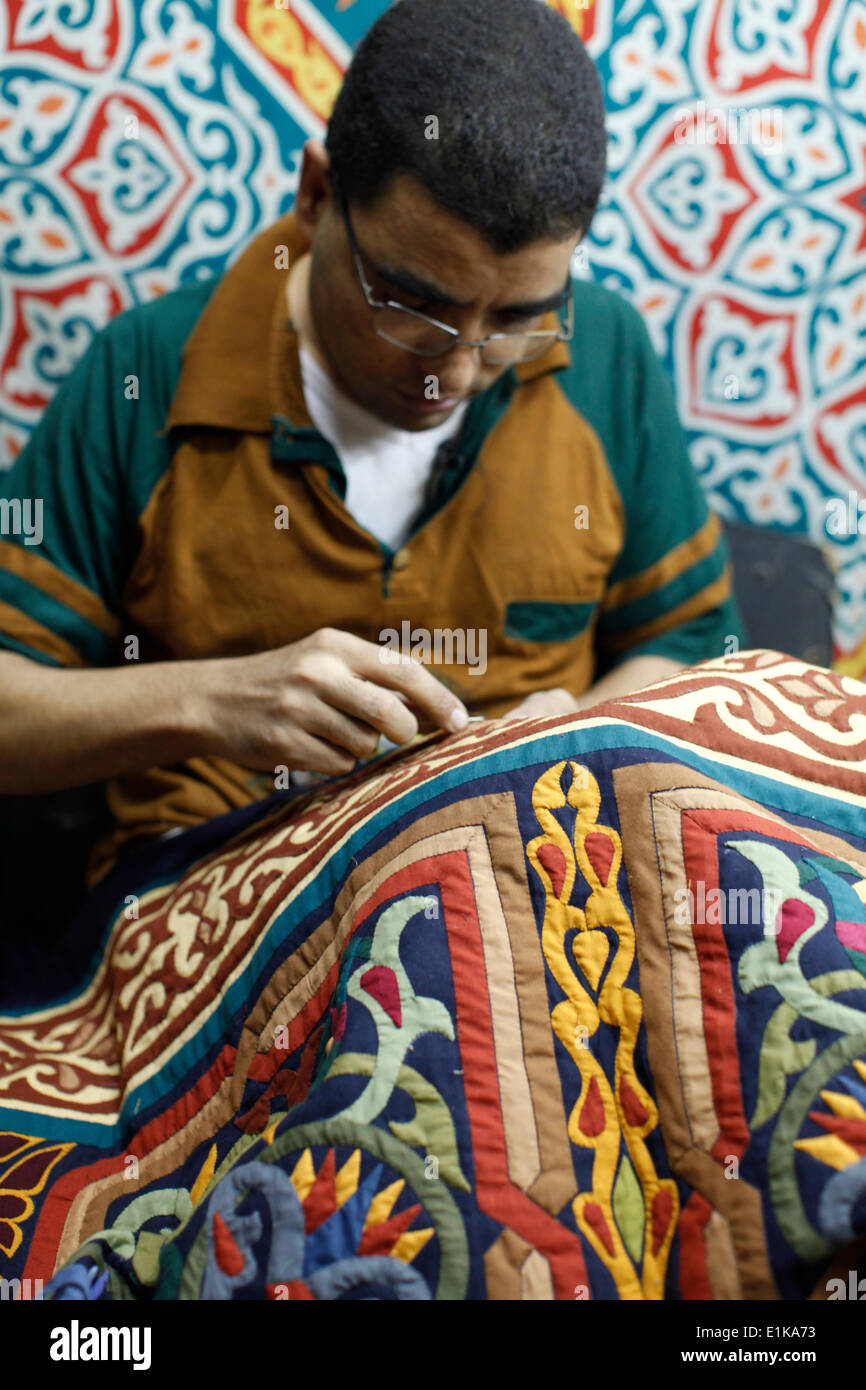 Mustapha Mohammad Allesy in his embroidery workshop financed by a  loan from the LEAD foundation microcredit institution Stock Photo