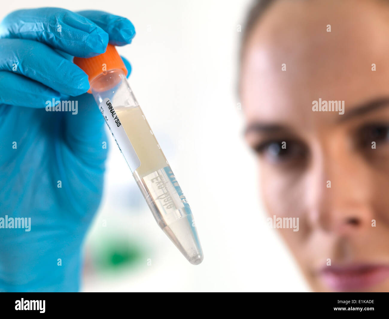 Female scientist holding an eppendorf tube with liquid inside. Stock Photo