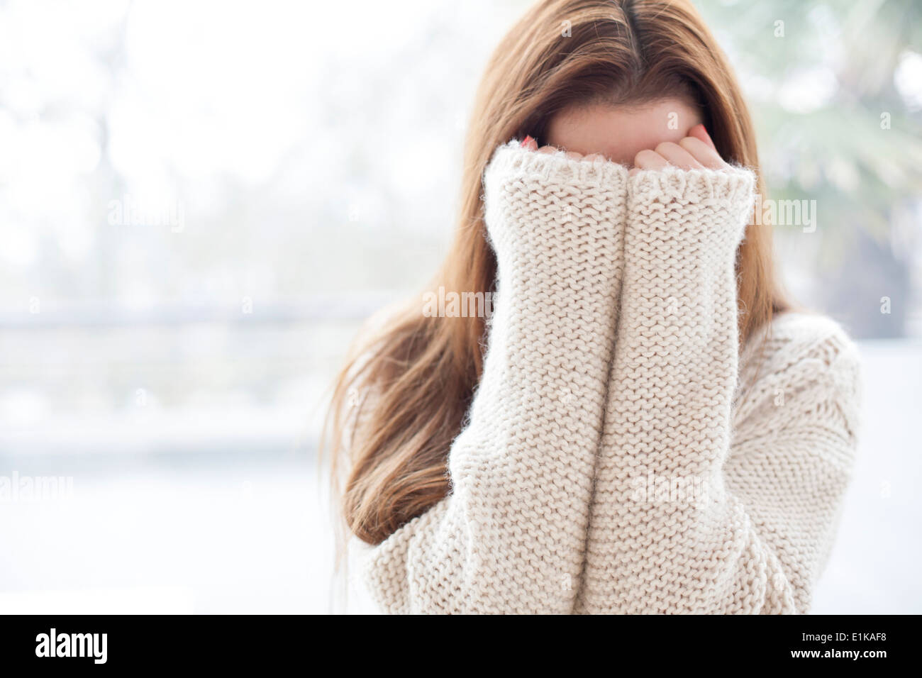 MODEL RELEASED Woman covering her face with her hands Stock Photo - Alamy