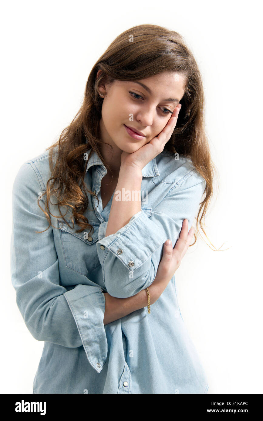 MODEL RELEASED Teenage girl with hand on chin studio portrait. Stock Photo