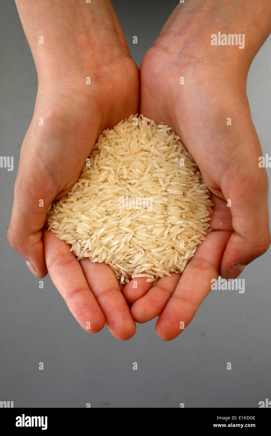 Rice in a girl's hands Stock Photo - Alamy