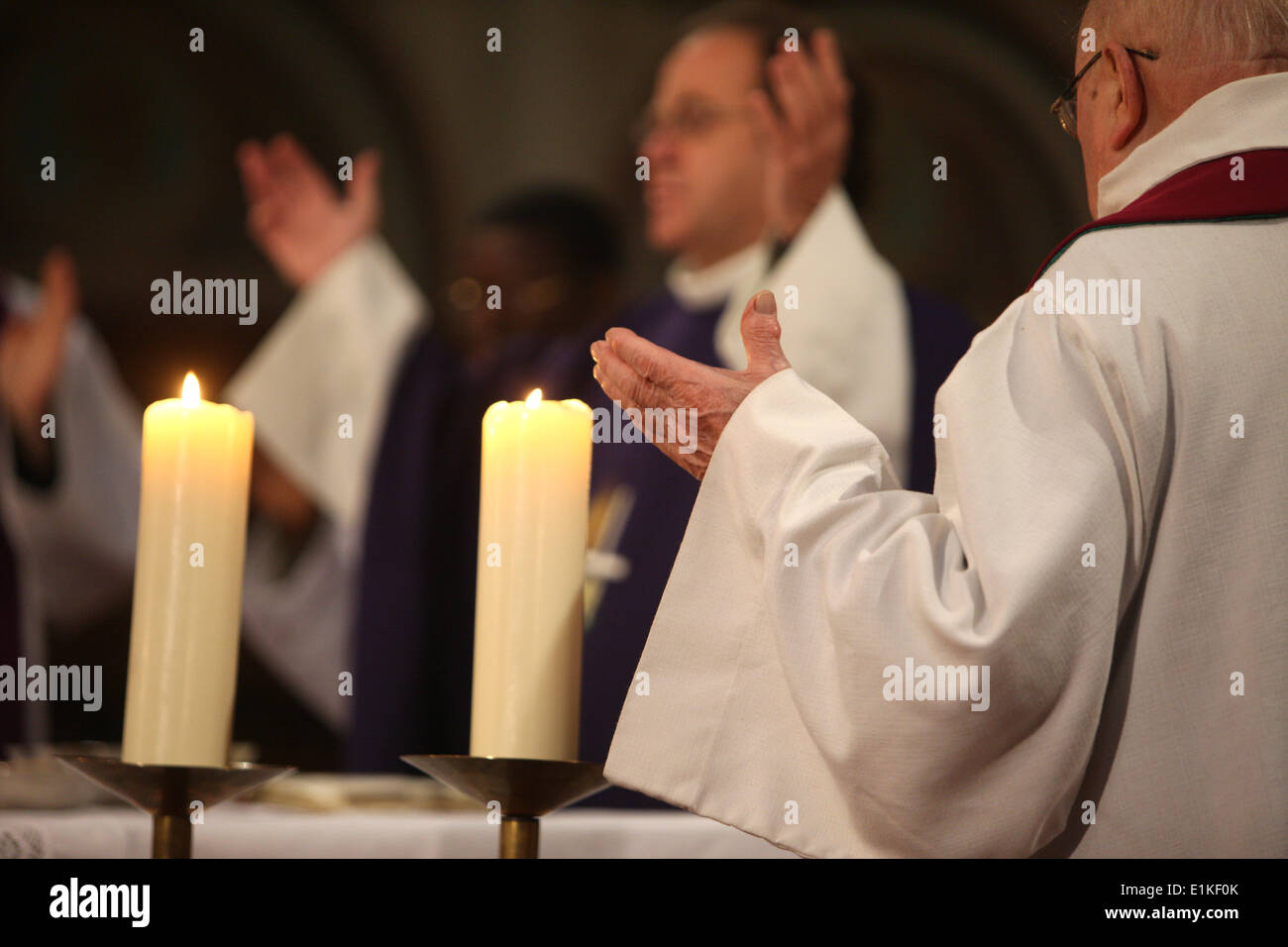 Praying clergy Stock Photo