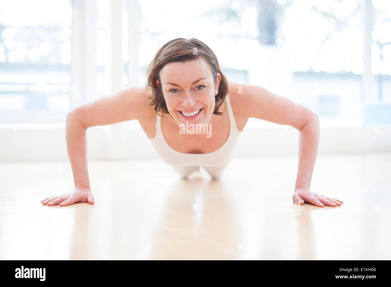MODEL RELEASED Woman doing press ups front view. Stock Photo