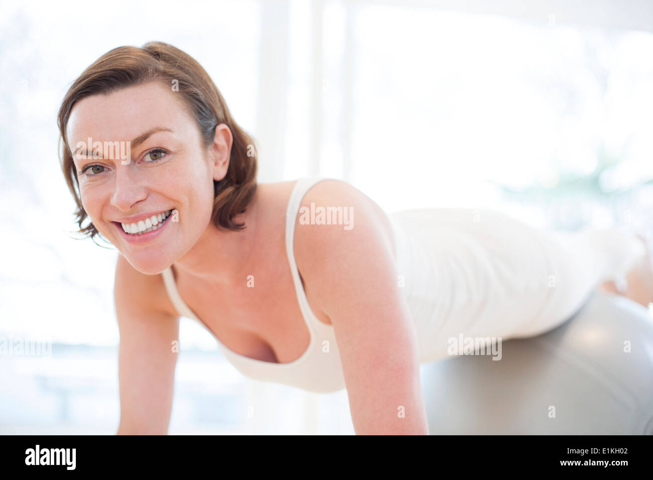MODEL RELEASED Woman balancing on an exercise ball. Stock Photo