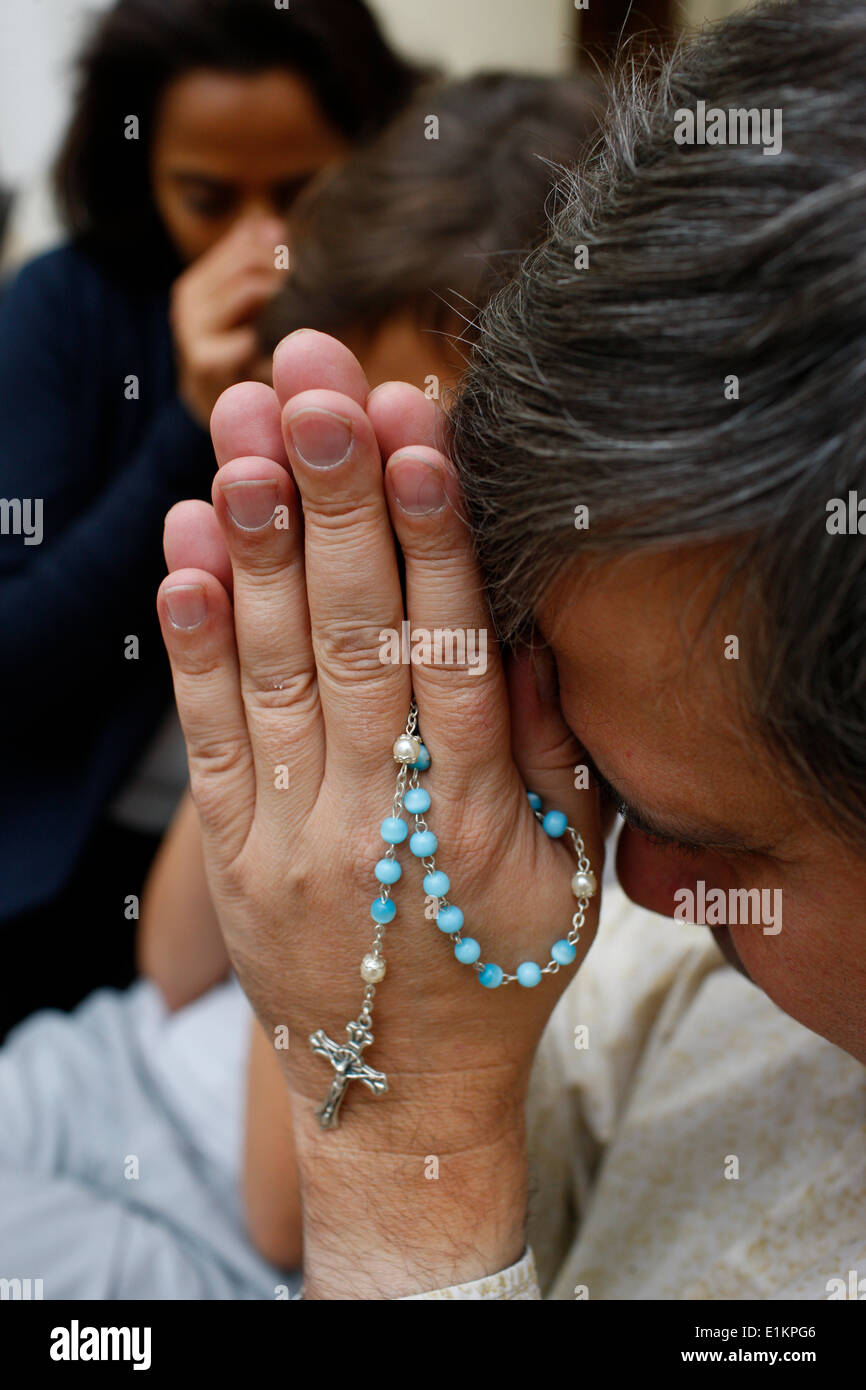 Family praying at home. Stock Photo