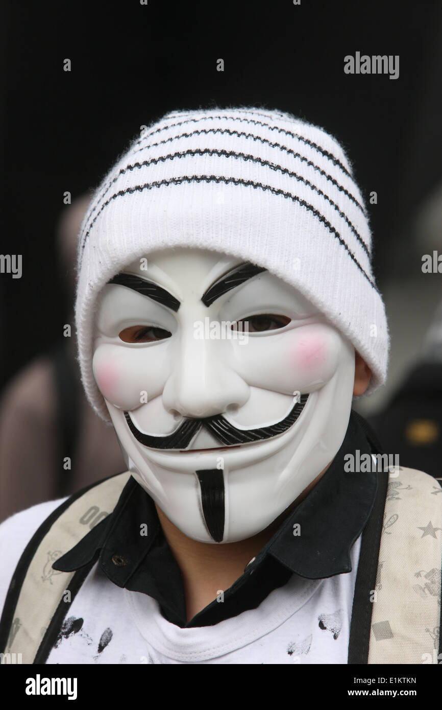 Protester wearing a Guy Fawkes mask , trademark of the Anonymous