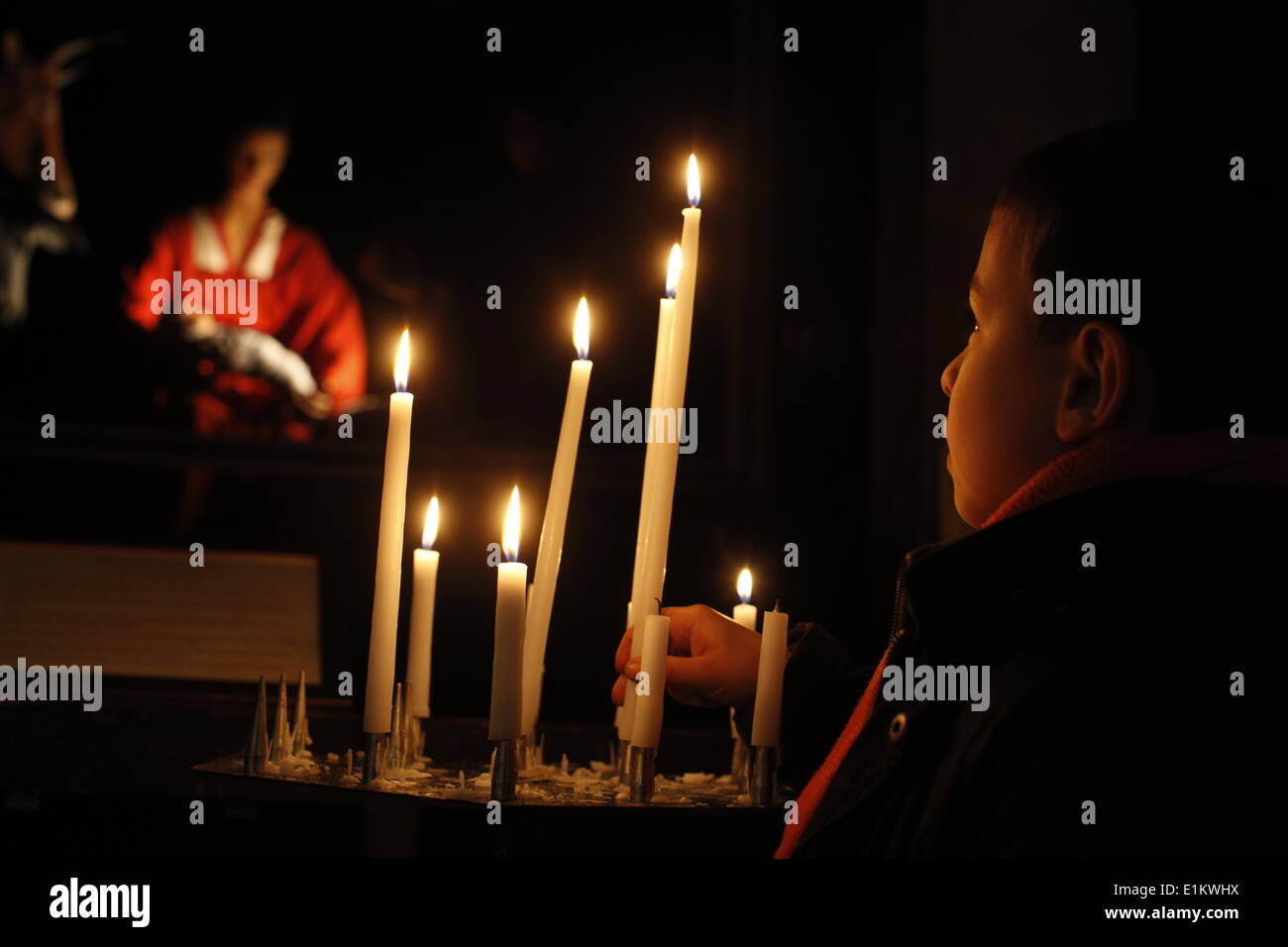 Child lighting a candle in a church Stock Photo - Alamy