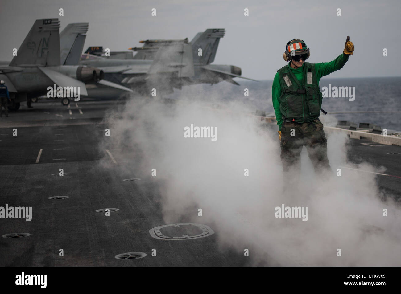 U.S. Navy Aviation Boatswain's Mate (Equipment) 2nd Class Tyler Stives inspects a catapult after