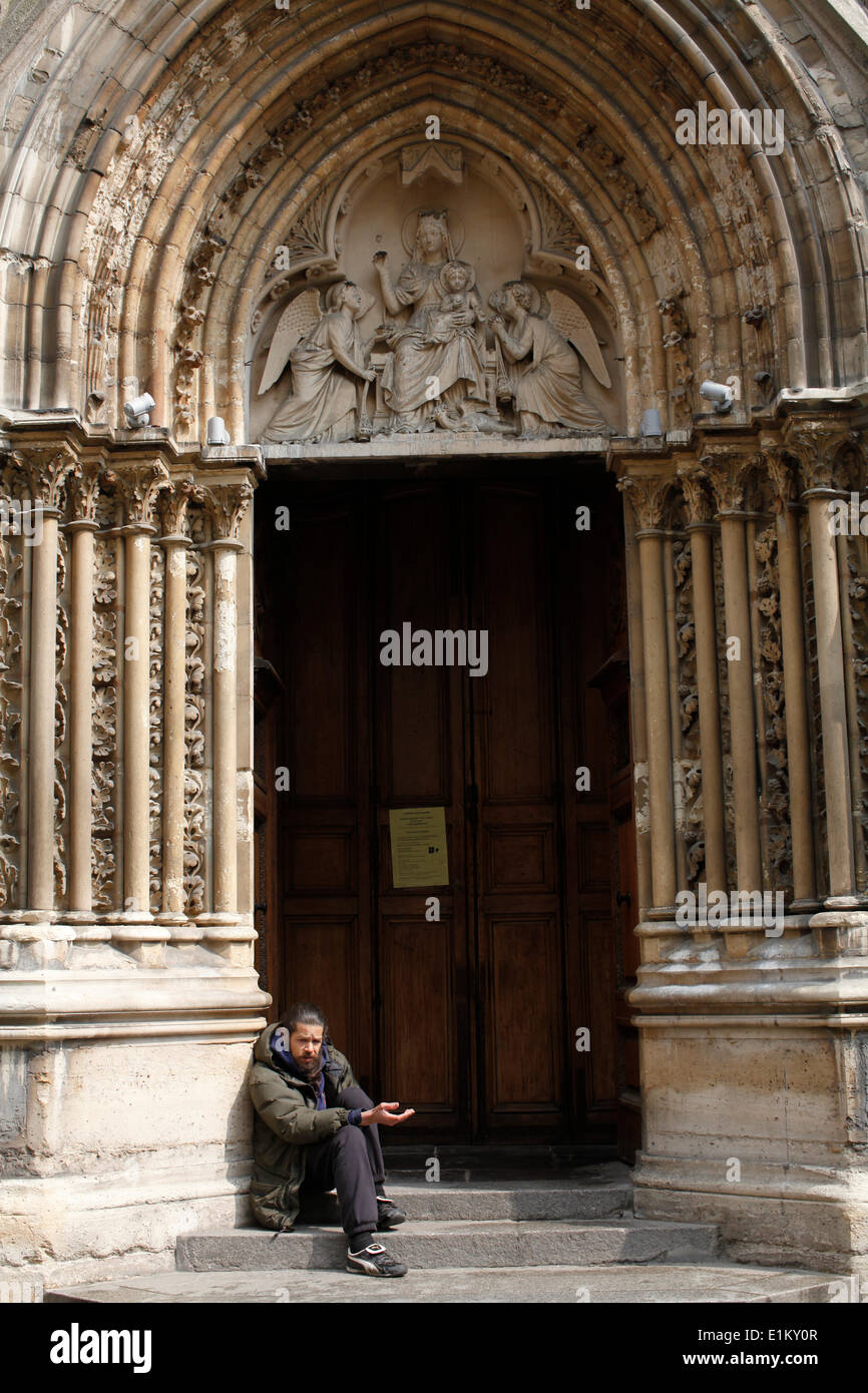 Beggar outside Saint Severin church Stock Photo