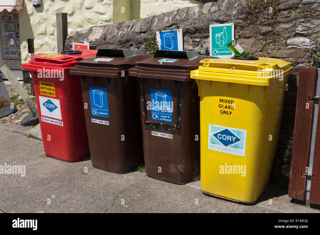 Coloured Recycling Bins in quayside in the cornish seaside village of Mevagissey Stock Photo