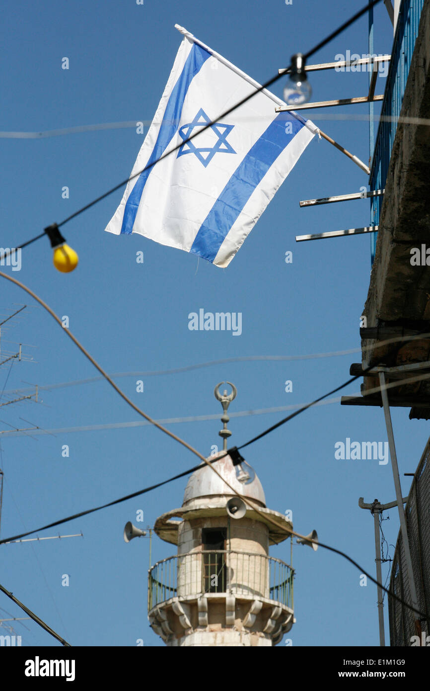Israeli flag and minaret in Jerusalem Stock Photo