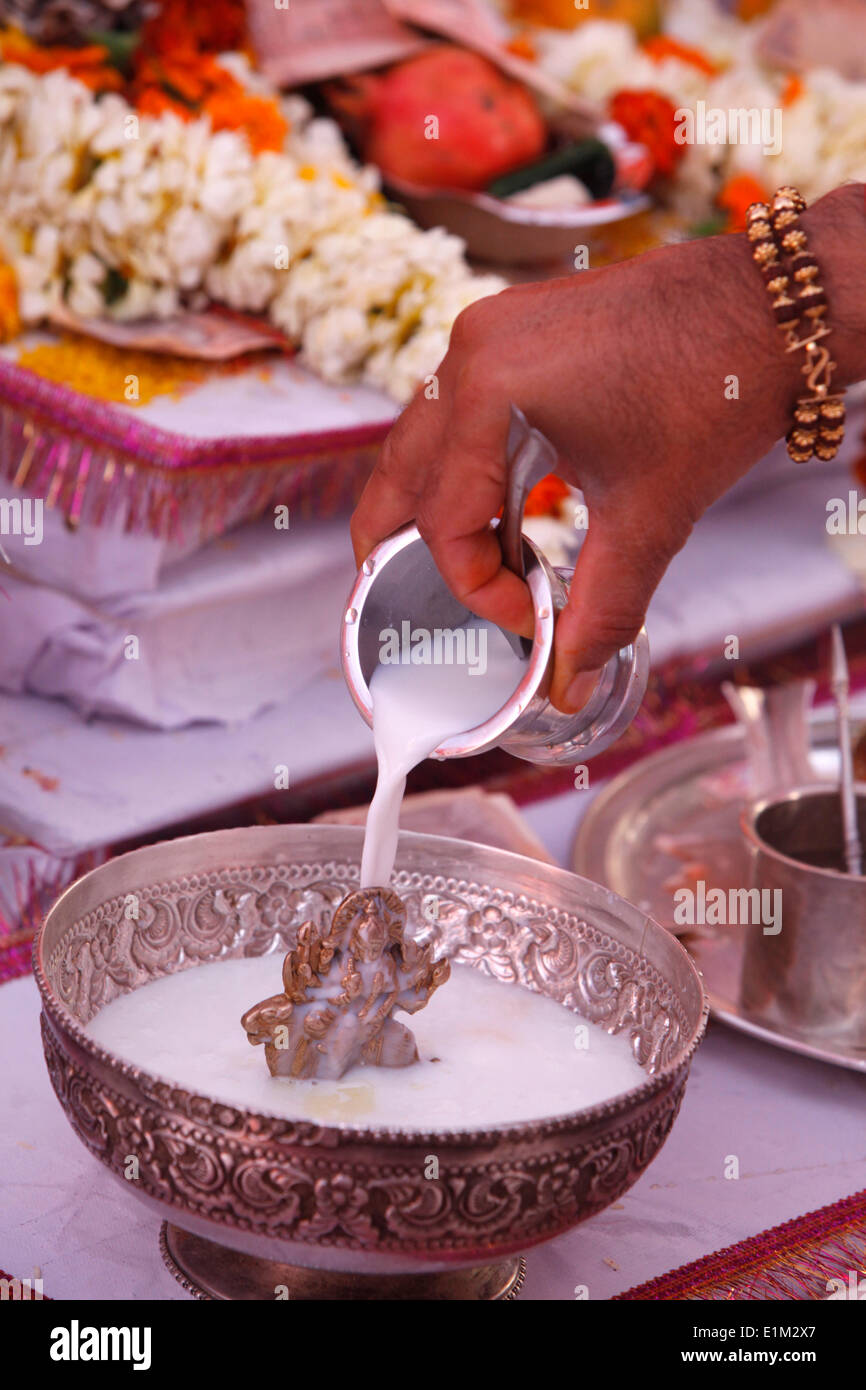 Puja in a Hindu temple bathing of a statue of goddess Durga with milk