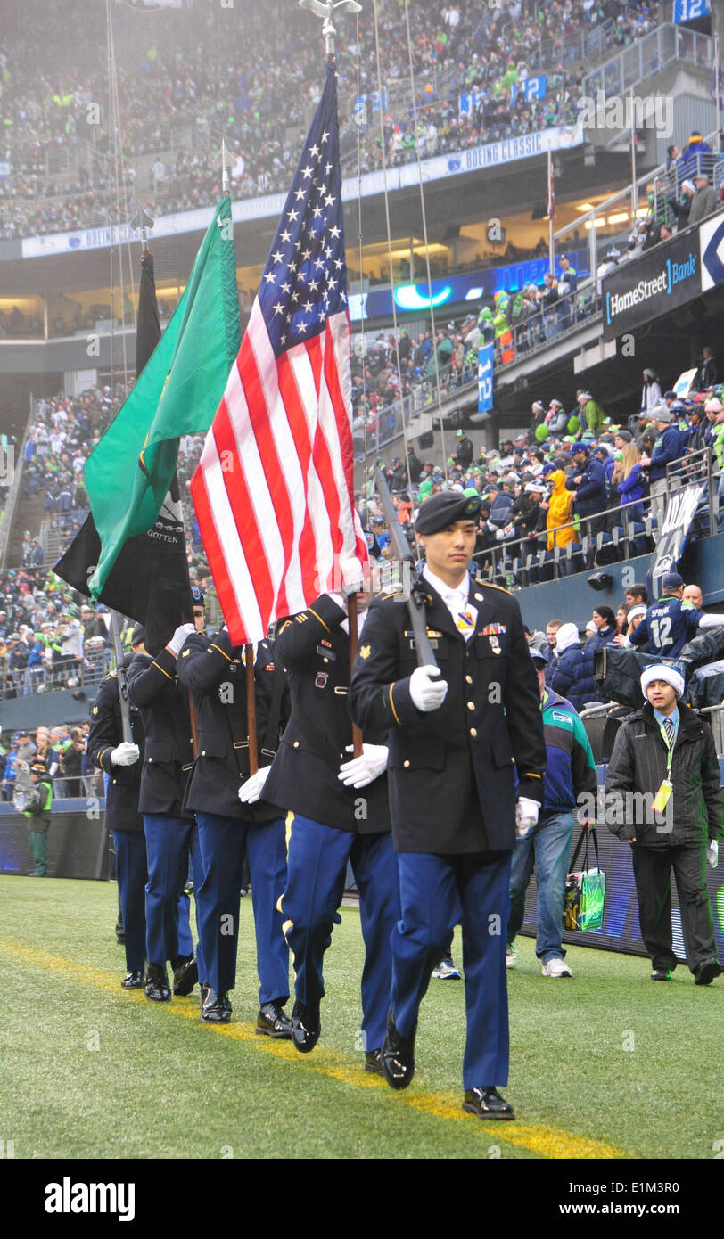 U.S. Army color guard members assigned to the 4th Stryker Brigade Combat Team, 2nd Infantry Division perform during a football Stock Photo
