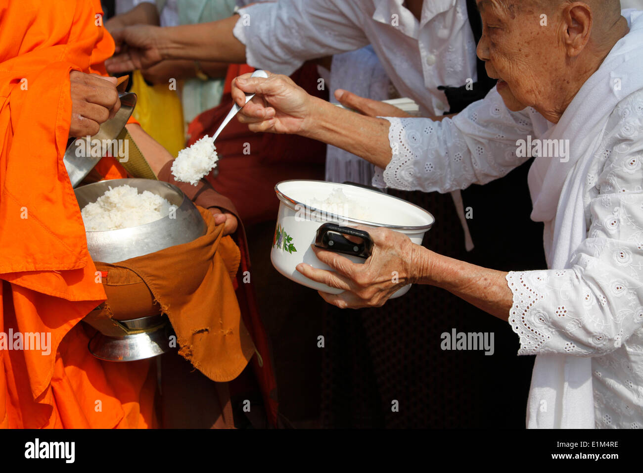 Monks receiving alms on Meak Bochea (Makha Bucha) holiday Stock Photo